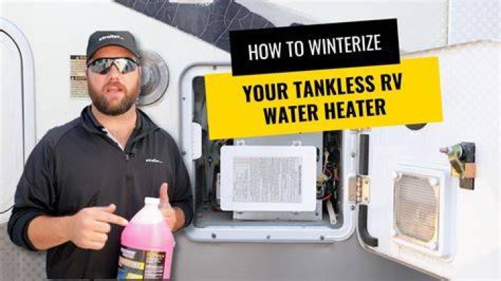 How do I fill the hot water tank on my RV?