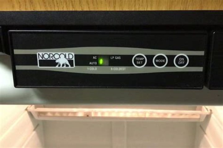 How do I lower the temperature on my Norcold RV refrigerator?